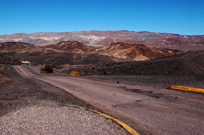 'Where to Go' by Jeff Hitchcock - depicting a long, empty, winding road in a landscape with mountains
